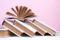 Open books, hardback colorful books on wooden table. pink background. Back to school. Copy space for text. Education business Royalty Free Stock Photo