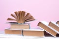 Open books, hardback colorful books on wooden table. pink background. Back to school. Copy space for text. Education business Royalty Free Stock Photo