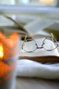 Open Books, Reading Glasses and Lit Candle Royalty Free Stock Photo