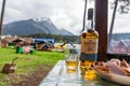 An open bottle of single malt whiskey Glen Livet founder`s reserve stand in a wooden gazebo against mountains