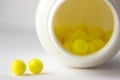 Open bottle witn yellow pills Royalty Free Stock Photo