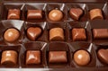 An open box of chocolates in close up. Assorted milk chocolate, praline and dark Royalty Free Stock Photo