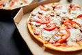 Open boxes with hot tasty italian sliced three pizzas on black background, delicious fast food, delivery concept, top view, copy s Royalty Free Stock Photo