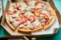 Open boxes with hot tasty italian sliced three pizzas on black background, delicious fast food, delivery concept, top view, copy s Royalty Free Stock Photo