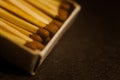 Open box of matches, macro photo, focus on one match. Concept with matches on a dark background Royalty Free Stock Photo