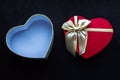 Open box in the shape of a heart with a bow on a black background. Romantic gift concept. Valentine`s Day Royalty Free Stock Photo