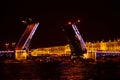 Open bridge over the river in the evening city. Drawbridge in Saint Petersburg with night lights