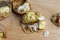 Open and broken walnut shells lying on the table Royalty Free Stock Photo