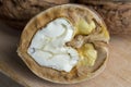 Open and broken walnut shells lying on the table Royalty Free Stock Photo