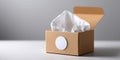 Open brown cardboard tissue box with white tissues inside on white surface and gray background Royalty Free Stock Photo