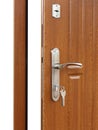 Open brown wooden door handle with lock. Royalty Free Stock Photo