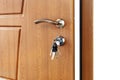 Open brown wooden door handle with lock. Royalty Free Stock Photo