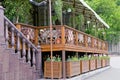 Open brown wooden restaurant veranda with flowerpots Royalty Free Stock Photo