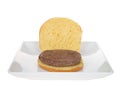 Open bun on square white plate with plain hamburger patty Royalty Free Stock Photo