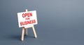 Open for business easel sign. Opening a business of establishments, resuming economic life after a long closure. Economy recovery Royalty Free Stock Photo