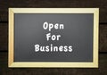 Open for business, words on blackboard