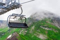 Open cabin lift cable car in the mountains in the clouds summer