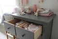 Cabinet drawers with baby clothes in child room Royalty Free Stock Photo