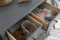 Open cabinet drawers with clothes and items in child room Royalty Free Stock Photo