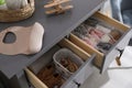 Open cabinet drawers with clothes and items in child room Royalty Free Stock Photo