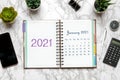 Open Calendar January 2021, glasses, cup of coffee, pen, smartphone, succulents on marble table Top view Flat lay Education, goals Royalty Free Stock Photo