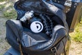 Open camera bag with DSLR, tripod, and ring light placed on grass and dirt Royalty Free Stock Photo