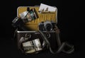 Open camera bag with old camera, flashlight and stuff Royalty Free Stock Photo