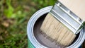 Open can of brown paint with brush Royalty Free Stock Photo