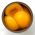 Open can of peach halves in syrup from above. Royalty Free Stock Photo