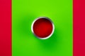 An open can of red paint on a green-red background Royalty Free Stock Photo