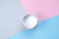 Open can with white paint on a pink-blue background Royalty Free Stock Photo