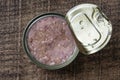 Open canned tuna in oil sauce on a wooden background, closeup, top view Royalty Free Stock Photo