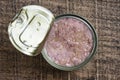 Open canned tuna in oil sauce on a wooden background, closeup, top view Royalty Free Stock Photo