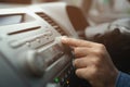 Open car radio listening. Car Driver changing turning button Radio Stations on His Vehicle Multimedia System. Royalty Free Stock Photo