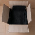 Open cardboard box with black foam for protection Royalty Free Stock Photo