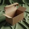 Open cardboard box with a corrugated texture, placed on a green fabric backdrop. Th Royalty Free Stock Photo