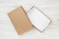 Open cardboard box with cover on wooden table, above view Royalty Free Stock Photo