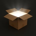 Open cardboard box on a dark background with a bright light emanating from inside. Royalty Free Stock Photo