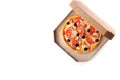 Open cardboard box with delicious pizza and space for text on white background, top view. Royalty Free Stock Photo