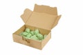 Open cardboard box with green packaging chips