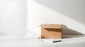 Open cardboard box, notebook, and pencil on white surface Royalty Free Stock Photo