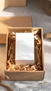 Open Cardboard Box with White Card Inside and Brown Shredded Paper Padding Royalty Free Stock Photo