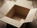 Open cardboard box on wooden surface with light and shadow play Royalty Free Stock Photo