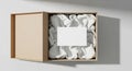 Open cardboard gift box with white fabric and blank card inside, studio shot Royalty Free Stock Photo