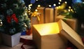 Open Christmas Box Gift Besides Small Christmas Tree. Glowing Li