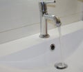 Open chrome faucet washbasin in bathroom