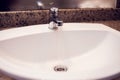 Open chrome faucet water washbasin in bathroom Royalty Free Stock Photo