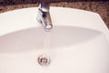 Open chrome faucet water washbasin in bathroom Royalty Free Stock Photo