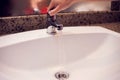 Open chrome faucet water washbasin in bathroom Royalty Free Stock Photo