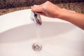 Open chrome faucet water washbasin in bathroom Royalty Free Stock Photo